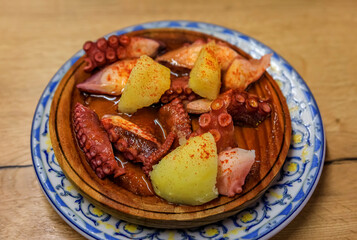 Basque pintxos octopus with potatoes and paprika in a bar, San Sebastian, Spain