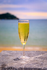 Sparkling Spanish cava wine at Concha bay beach in San Sebastian Spain at sunset