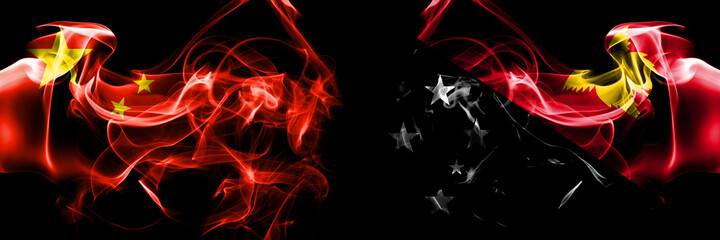 Flags of China, Chinese vs Papua New Guinea. Smoke flag placed side by side on black background.