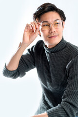 smart glasses asian male thinking action pose,attractive casual cloth adult asian male wear sweater and glasses studio shot hand touch glasses with think and concentrate smile with confident
