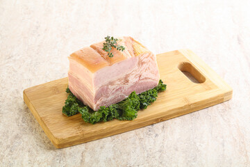 Cut of pork bacon over board