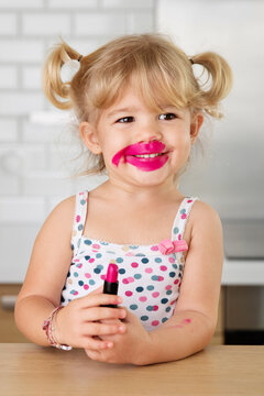 Funny Toddler Girl Smiling With Messy Lipstick Face