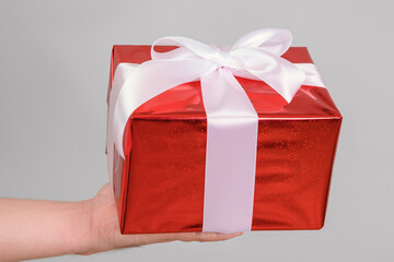 Big red gift box in a man's palm