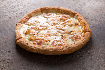 Pizza with cheese on a dark background. Copy space.