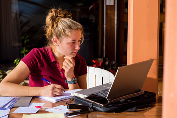 young woman or student teleworking on the terrace