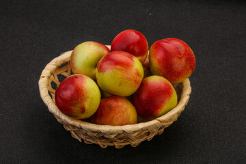 Sweet small nectarines in the basket