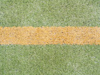Yellow marks and lines on outdoor football or hanball playfield.