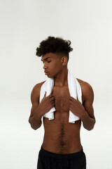 Fototapeta premium Black pensive sportsman with towel and closed eyes