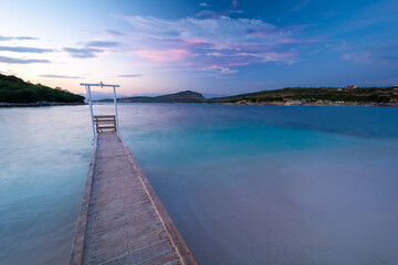 Obraz premium pier at the sea during dusk in Ksamil in Albania