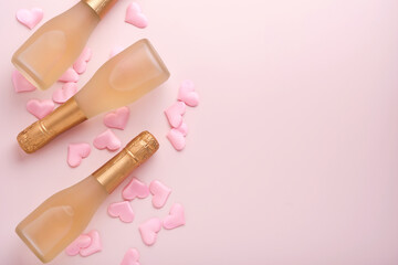 Valentines day greeting card with three champagne bottles and on pink background. Top view with space for greetings. Greeting card with copy space.