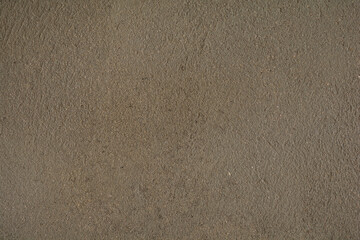 Fototapeta na wymiar Full frame of dark brown grainy wall background texture