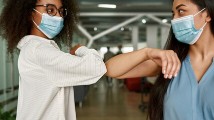 Women elbow bumping while meet after Covid-19