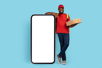 Delivery App. Black Courier Man With Pizza Boxes Standing Near Blank Smartphone