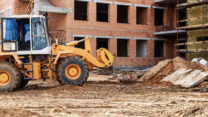Plakat A forklift at a construction site is lifting a reinforced concrete slab. Construction machine. Industry.