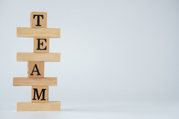Word TEAM build be wooden blocks on white background.teamwork for brainstorming together, no people, business concepts.