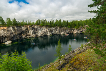 Fototapeta na wymiar Boats on Marble Lake in Ruskeala Mountain Park in Karelia Russia