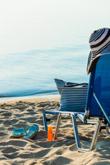 Obraz premium chair and beach accessories near sea. Summer vacation