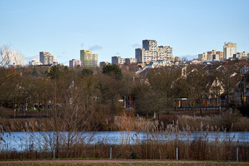 Skyscraper on a hill in the city. Recreation area (Naherholungsgebiet) with lake in foreground. Landscape in winter in Germany, Stuttgart.