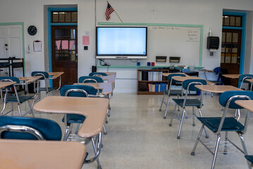 Empty schoolroom with interactive whiteboard for teaching students in high, middle, and elementary school.