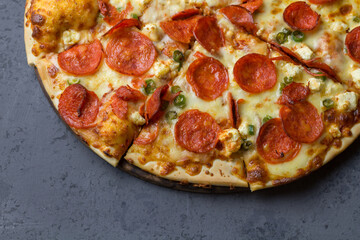 Salami and chili pizza on grey background