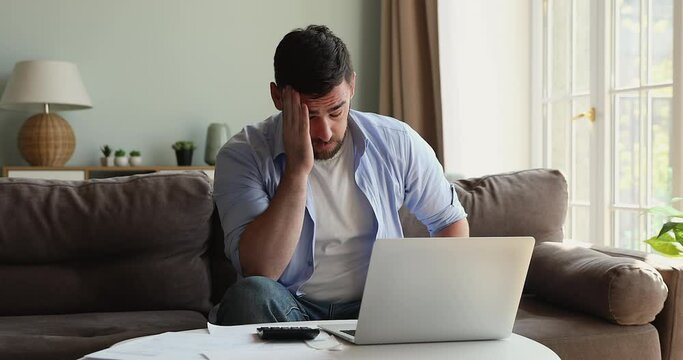 Anxious young man feel depressed unable to balance budget successfully get debt deficit try to find mistake in calculations. Annoyed male count business costs think on bankruptcy risks too high taxes