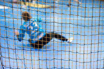Handball goalkeeper or mini football behind the net. Blur, selective focus on goal net