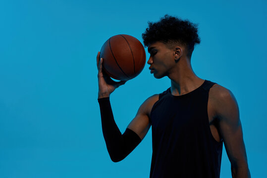 Black thoughtful sports man hold basketball ball