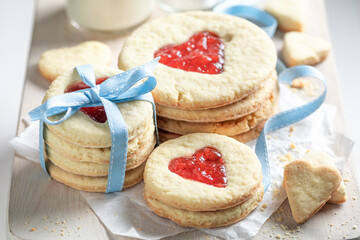 Homemade biscuits for valentine with heart shape and red jam.