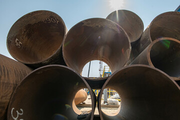 stacked pipes on a construction site large