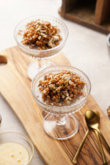 Traditional east european (ukrainian, polish, belarusian) religious christmas dish kutia made of wheat, poppy seeds, honey, walnuts and dried berries. modern style in champagne glasses