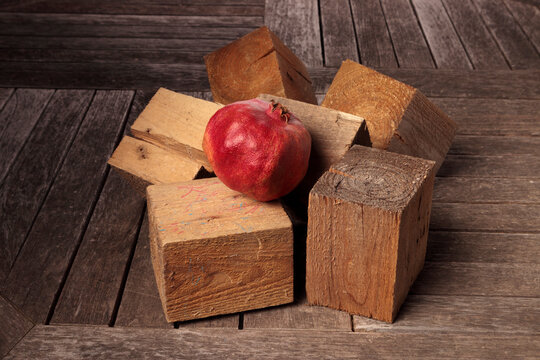 Still life with pomegranate and wooden cubes.