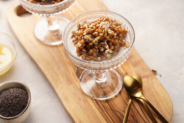 Traditional east european (ukrainian, polish, belarusian) religious christmas dish kutia made of wheat, poppy seeds, honey, walnuts and dried berries. modern style in champagne glasses