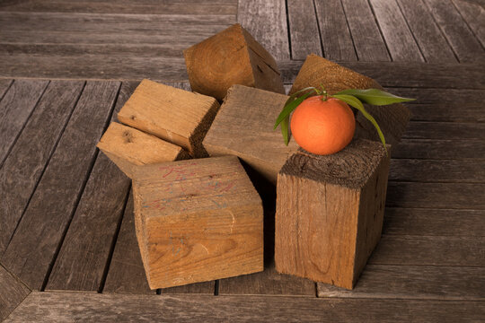 Still life with tangerine and wooden cubes.