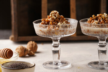 Traditional east european (ukrainian, polish, belarusian) religious christmas dish kutia made of wheat, poppy seeds, honey, walnuts and dried berries. modern style in champagne glasses