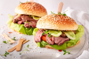 Tasty hamburger with lettuce, beef and pickles