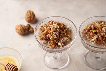 Traditional east european (ukrainian, polish, belarusian) religious christmas dish kutia made of wheat, poppy seeds, honey, walnuts and dried berries. modern style in champagne glasses