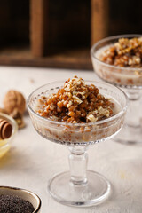 Traditional east european (ukrainian, polish, belarusian) religious christmas dish kutia made of wheat, poppy seeds, honey, walnuts and dried berries. modern style in champagne glasses