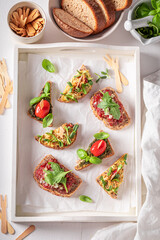 Healthy bruschetta with pesto and tomato for breakfast