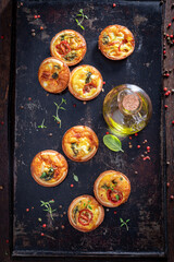 Homemade mini tart with mushroom and cheese. Vegetarian party food.