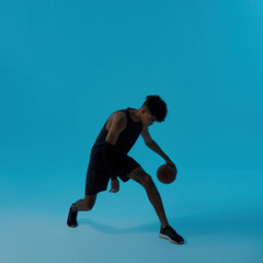 Fototapeta na wymiar African male player dribbling with basketball ball