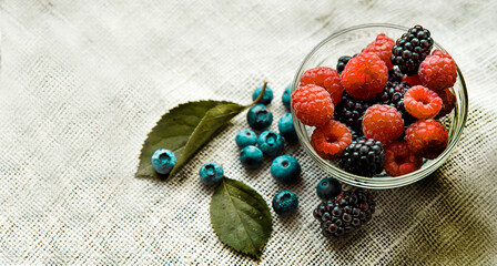 fruit from above in a glass dish with blueberries and raspberries flat lay
