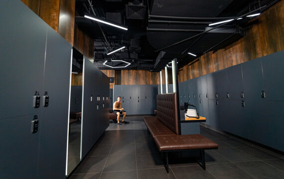 Modern dark locker room in gym. Luxury loft modern fitness club.