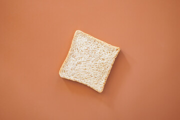 Single whole wheat bread on brown background