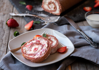 Delicious strawberry roll cake with white cream, homemade baked dessert