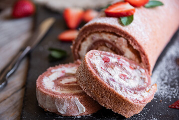 Delicious strawberry roll cake with white cream, homemade baked dessert