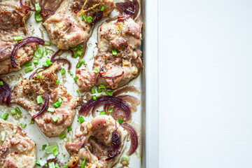 Sheet Pan chicken with onions close-up. Baked chicken fillet with onions