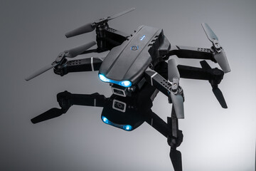 drone quadcopter with digital camera and sensors on black background. a black quadcopter with a camera on a black background.