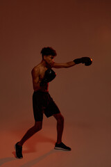 Fototapeta na wymiar Side of black boxer boxing during training