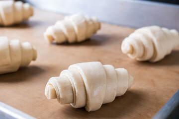 Fototapeta na wymiar Unbaked Croissant on baking tray