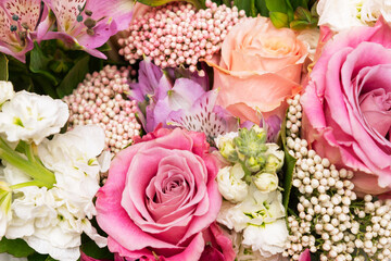 A bouquet of colorful pink and orange roses. Mix of flowers, spring. Floral background. Wallpaper